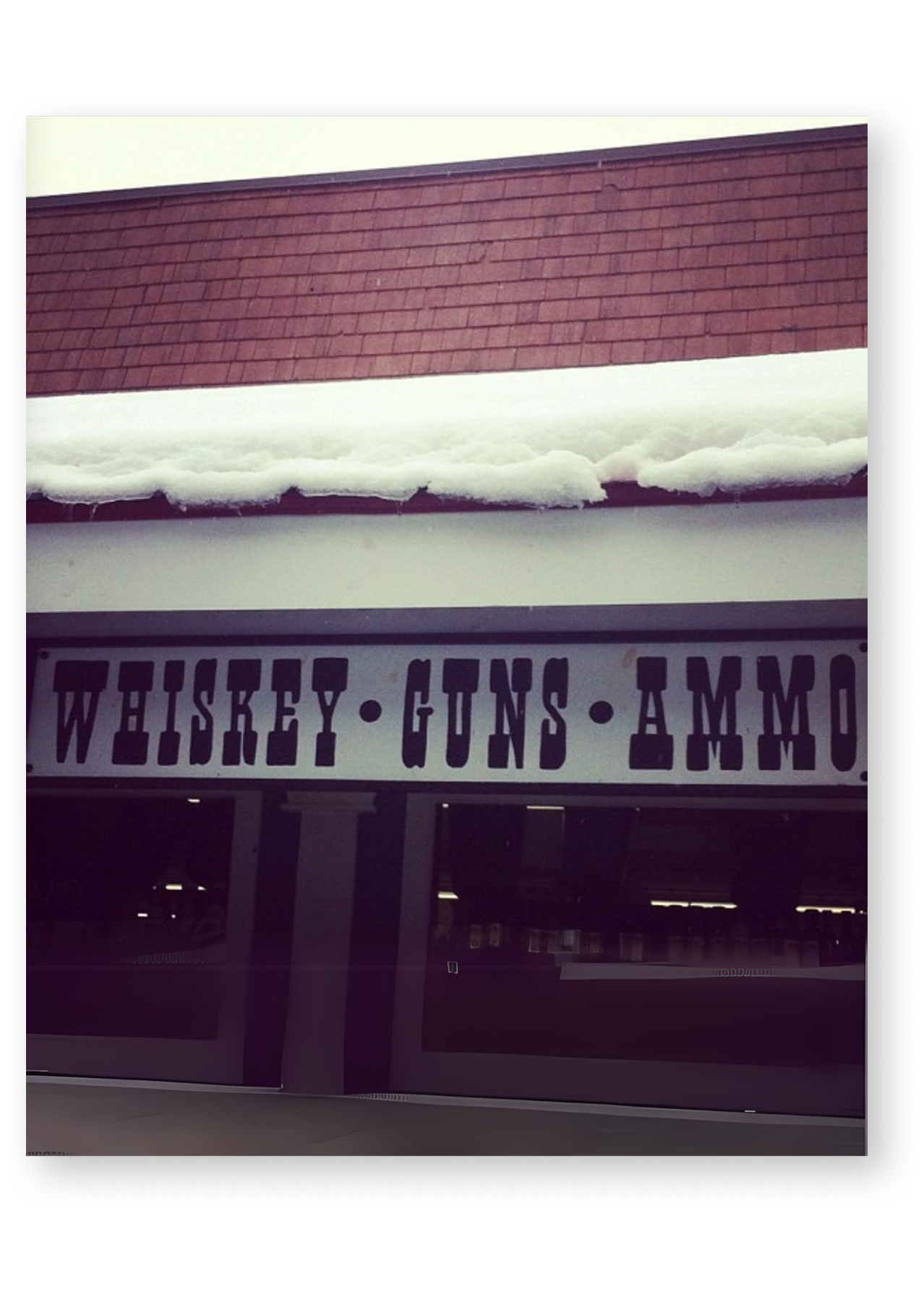 general store sign advertising whiskey, guns and ammo